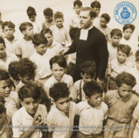 A Brother or the La Salle Order leads children in school song (#5382, Lago , Aruba, April-May 1944), Morris, Nelson
