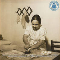 Aruban mother of Raymundo Feliciano (Lago Apprentice) ironing (#5417, Lago , Aruba, April-May 1944), Morris, Nelson