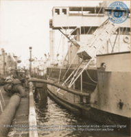 Pump line carrying crude from lake tanker (#12009, Lago , Aruba, April-May 1944), Morris, Nelson