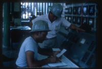 Help us describe this picture! (People at Work, Lago, ca. 1966), Lago Oil and Transport Co. Ltd.