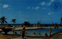 Swimming pool and ocean at the new Aruba Caribbean Hotel and Casino (Postcard, ca. 1962)