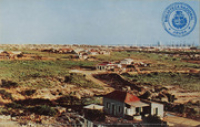 View on San Nicolas, Aruba. Background: Lago Oil Company (Postcard, ca. 1966)