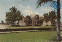 Cultural Centre (Postcard, ca. 1969) In this modern air-conditioned Cultural Centre of Aruba many famous international artists have performed. In foreground the statue of the late Lloyd G. Smith, on his recommendations Aruba was chosen as the place to build the Lago Oil Refinery