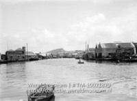 Curacao. Gezicht op het Rifwater gezien van de brug bij het Brionplein af; Rivier in Willemstad met aan beide zijden van de rivier woningen (Collectie Wereldmuseum, TM-10021879)