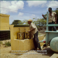 Mannen halen water bij een waterput waarbij het water wordt opgepompt door middel van windkracht; Boeren halen water uit een punt, waar het water opgepompt wordt met windkracht. Fontein. (Collectie Wereldmuseum, TM-20029698), Lawson, Boy