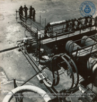 Men Cleaning Heat Exchanger; Expansion Bends in foreground (#4585, Lago , Aruba, April-May 1944), Morris, Nelson
