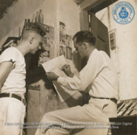 Preparation of ARUBA ESSO NEWS - Editor checking proofs (#4681, Lago , Aruba, April-May 1944)