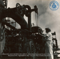 Operator manipulating valves on Exchanger bundles (#4914, Lago , Aruba, April-May 1944), Morris, Nelson