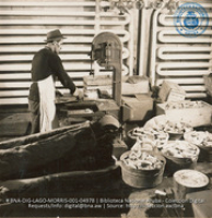 Cold-storage workmen sawing loins of pork (#4978, Lago , Aruba, April-May 1944), Morris, Nelson