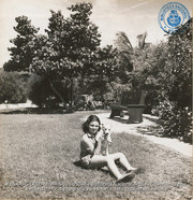 Young American girl of Colony in garden of one of the Bungalows (#5048, Lago , Aruba, April-May 1944), Morris, Nelson