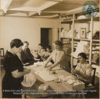 The Dutch 'womens' group of the Princess Irene Committee meets to cut out patterns which the American ladies sew up later in the week (#5129, Lago , Aruba, April-May 1944), Morris, Nelson
