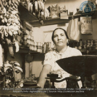 Mrs. Feliciano supplements family income by running a typical Aruban country store (#5340, Lago , Aruba, April-May 1944), Morris, Nelson