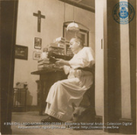 Father Meester, Parish Priest of Santa Cruz Catholic Church, in his study (#5394, Lago , Aruba, April-May 1944), Morris, Nelson