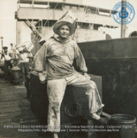 Unloading vegetables from Venezuela, while the crude is being pumped out of the holds of the lake tankers (#12000, Lago , Aruba, April-May 1944)