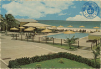 Divi Divi Beach Hotel - Aruba, Netherlands Antilles, pool side terrace and Pelican bar, overlooking snow white Eagle Beach (Postcard, ca. 1970)